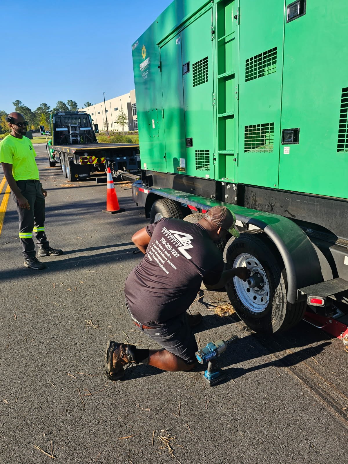 Technician replacing a tire on a generator equipment trailer in Sandersville, Georgia.