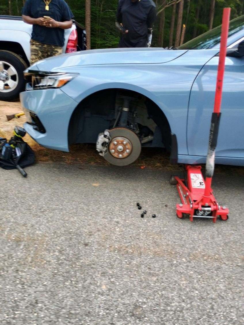 Passenger car during a roadside spare tire change in Siloam, Georgia.